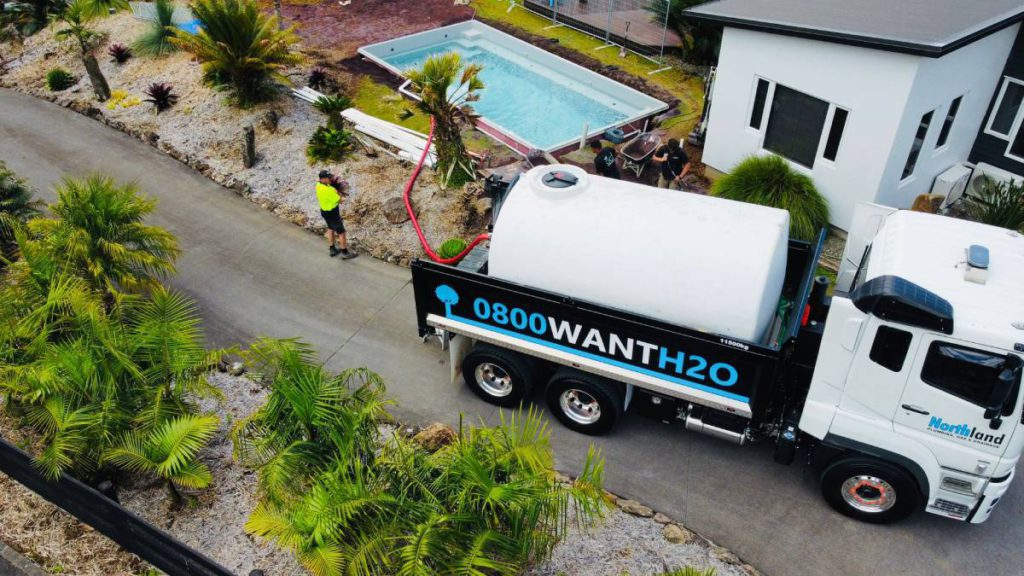 Aerial view of Water Delivery Truck filling a swimming pool